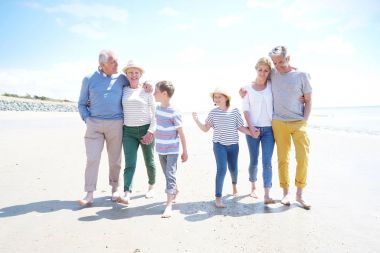 Family s walking on the beach clipart
