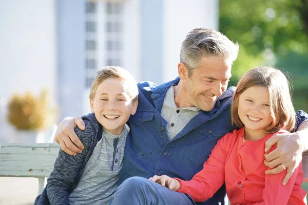 Portrait of father with kids sitting o — Stock Photo, Image