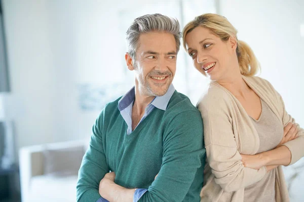 Couple standing back to back at home — Stock Photo, Image
