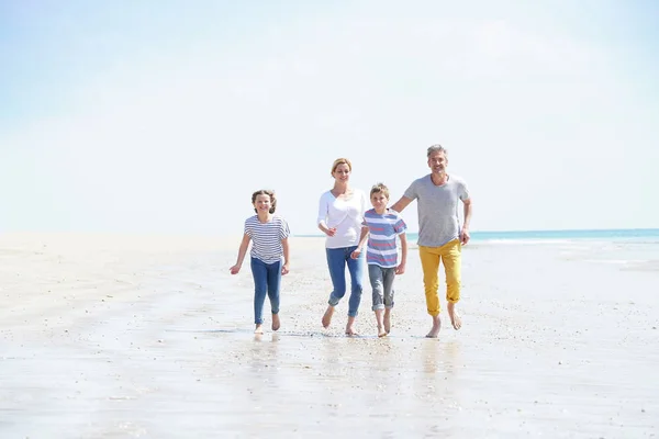 Familywalking on sandy beach — Stock Photo, Image