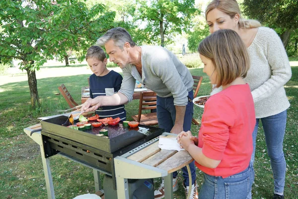 Family preparing grilled meet — Stock Photo, Image