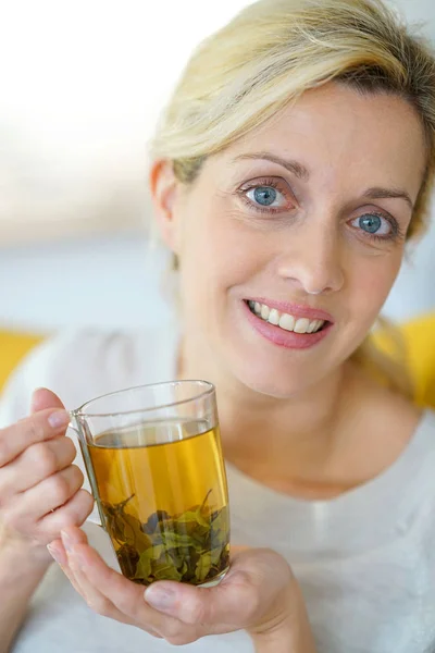 Woman drinking plants infusion — Stock Photo, Image