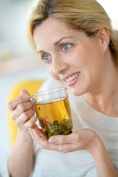 Woman drinking plants infusion — Stock Photo, Image