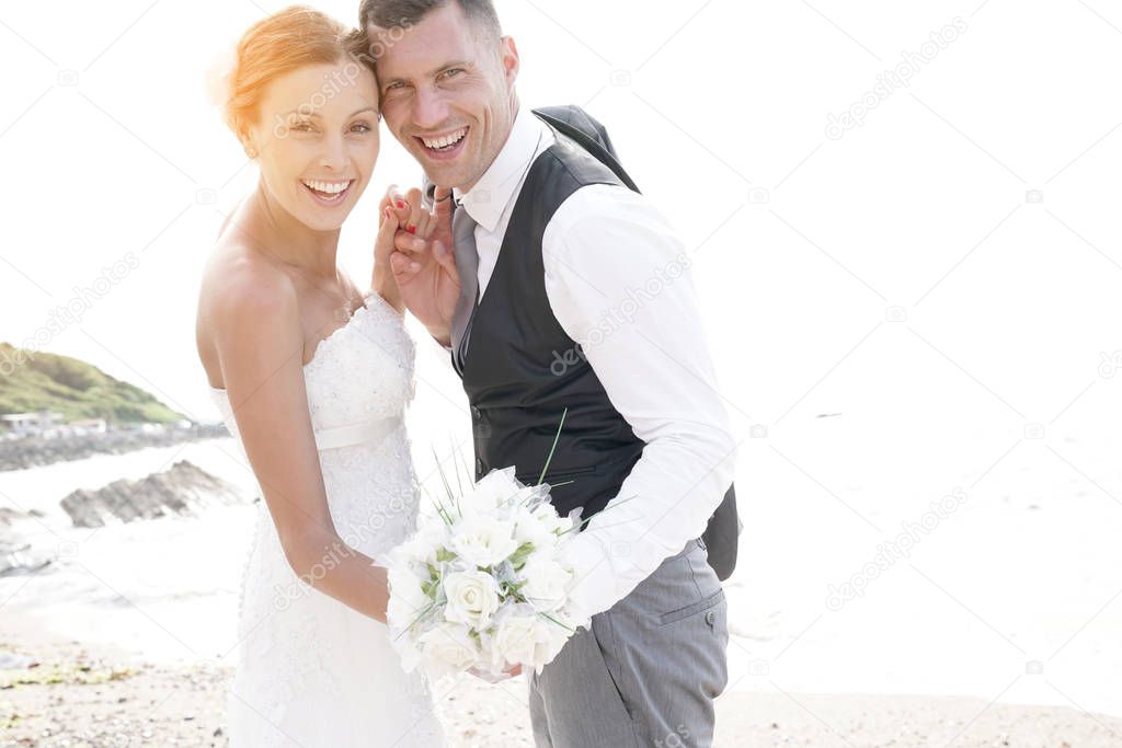 happy bride and groom on the beach 