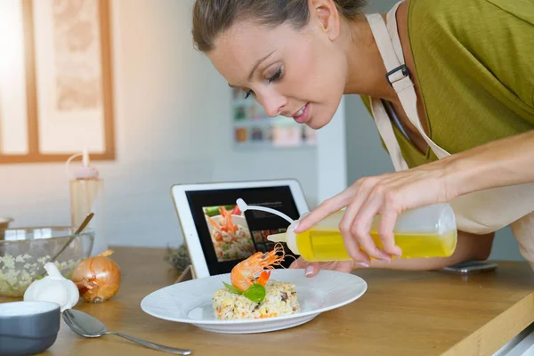 Woman in kitchen testing recipe — Stock Photo, Image