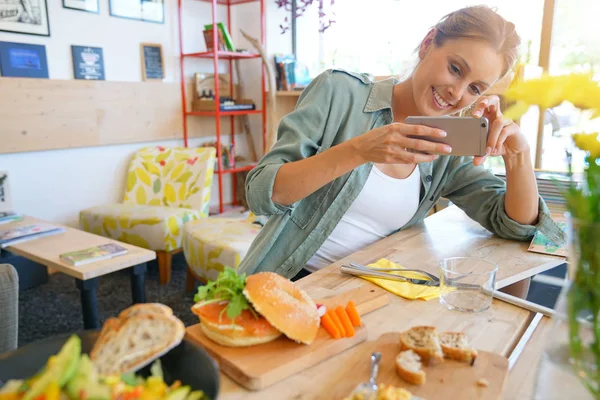 Girl  taking picture of colourful dish — Stock Photo, Image