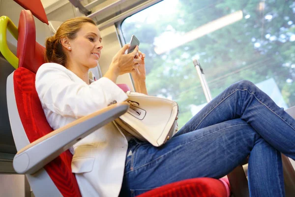 Young woman connected with smartphone — Stock Photo, Image