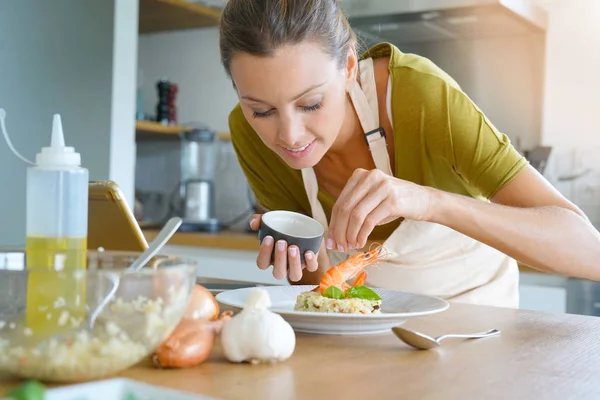 Woman in kitchen testing recipe — Stock Photo, Image