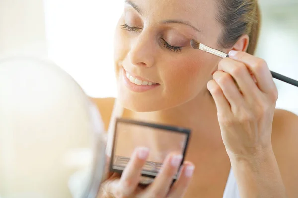 Woman applying eyeshadow on — Stock Photo, Image