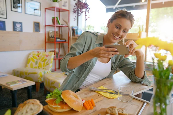 Girl  taking picture of colourful dish — Stock Photo, Image
