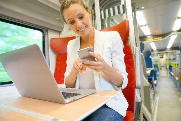Businesswoman in train working — Stock Photo, Image