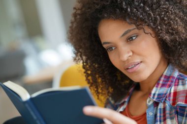  Kadın koltuk içinde kitap okumak