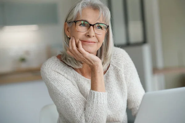 Senior woman at home websurfing