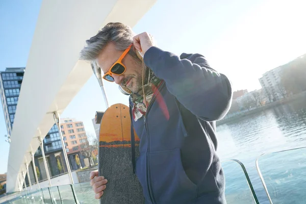Trendy guy with skateboard — Stock Photo, Image