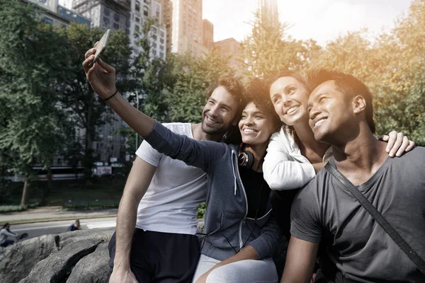 Friends in sports outfit using smartphone — Stock Photo, Image