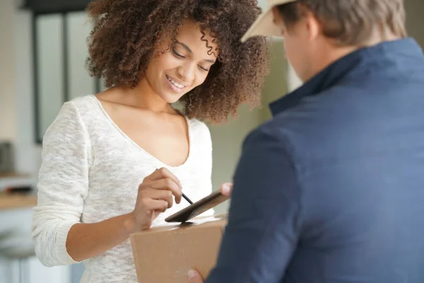 woman receiving package from delivery man