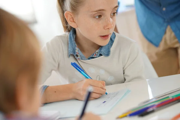 Girl taking notes in class Stock Image