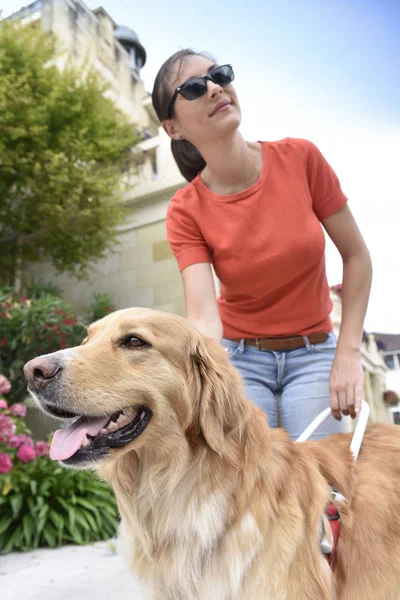 Woman petting her guide dog — Stock Photo, Image