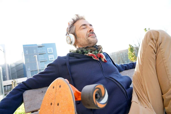 trendy guy  relaxing on bench