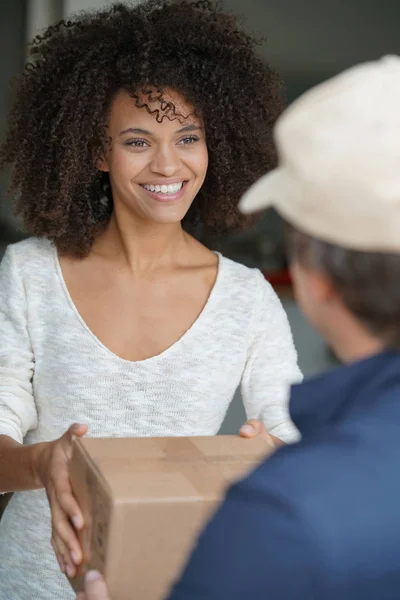 woman receiving package from delivery man