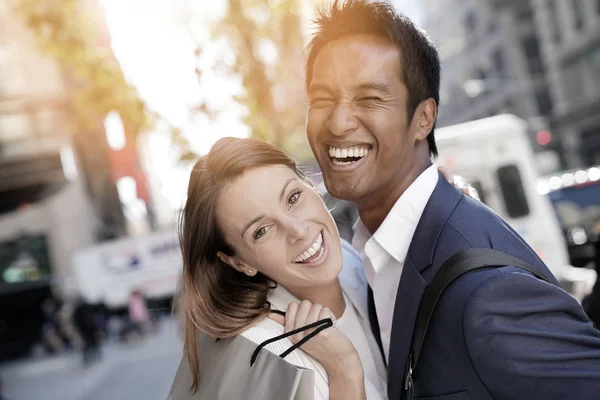 Cheerful couple doing shopping — Stock Photo, Image