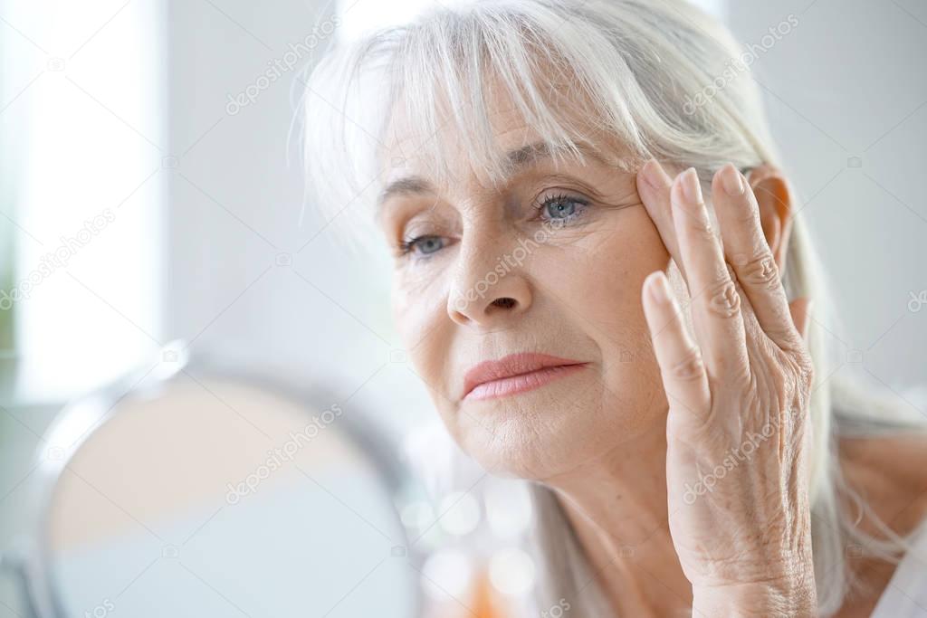  woman applying anti-aging cream