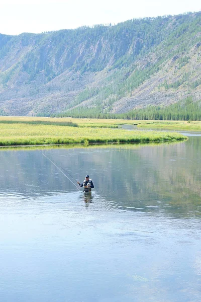 Fly-fisherman fishing in Madison river