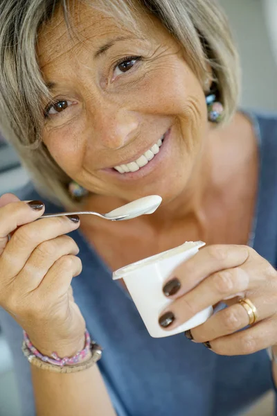 Portrait Senior Woman Eating Yoghurt Royalty Free Stock Images