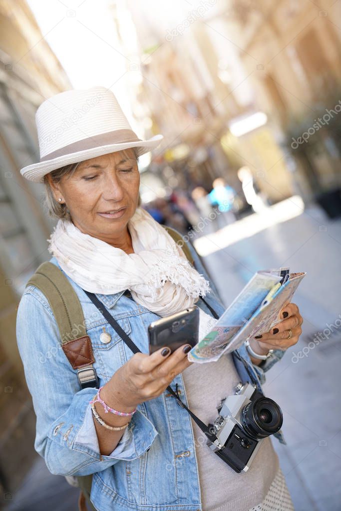 woman using smartphone and map