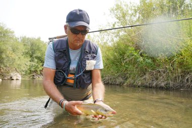 Kahverengi alabalık yakalamak balıkçı