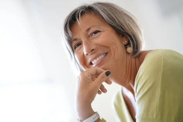 woman at home relaxing in armchair