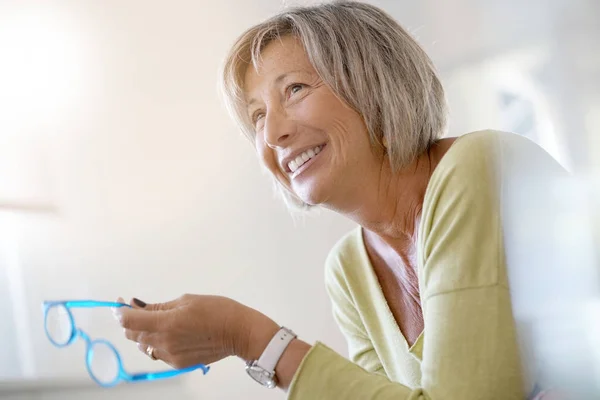 Woman at home relaxing in armchair — Stock Photo, Image