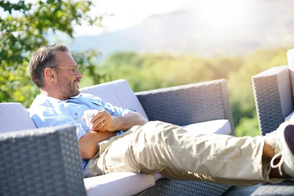 Smiling Mature Man Relaxing Outdoor Sofa — Stock Photo, Image