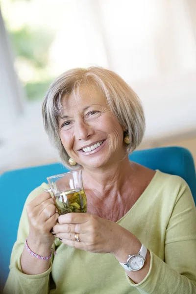 Woman relaxing in armchair — Stock Photo, Image