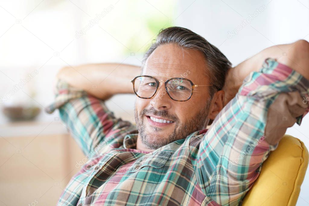 man with eyeglasses relaxing 