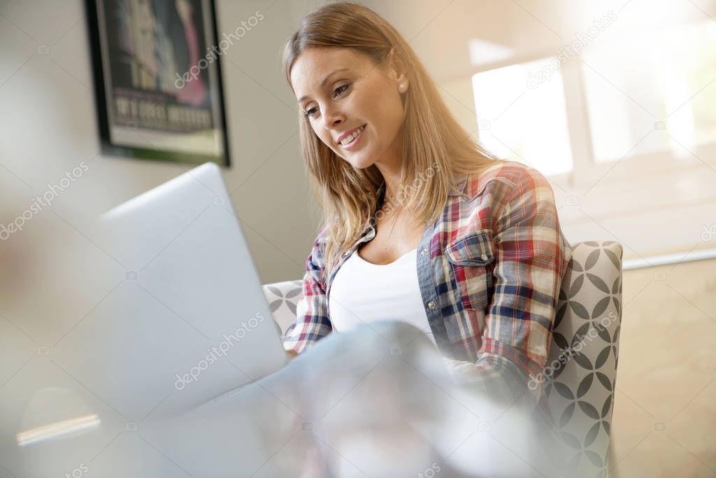 woman using laptop at home