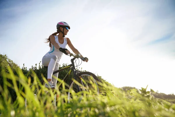 Mujer en traje deportivo montar en bicicleta — Foto de Stock