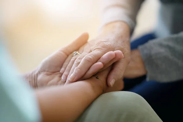 nurse holding old woman hands