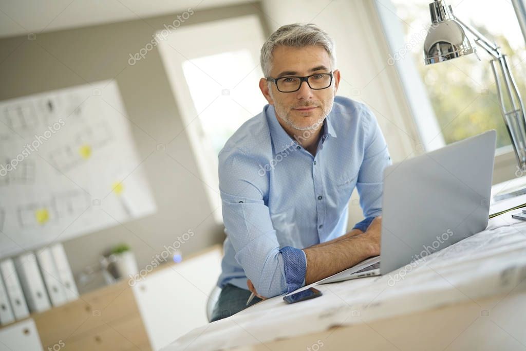 Portrait of architect looking at camera in office