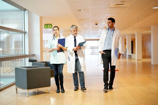 Medical people walking in hospital corridor