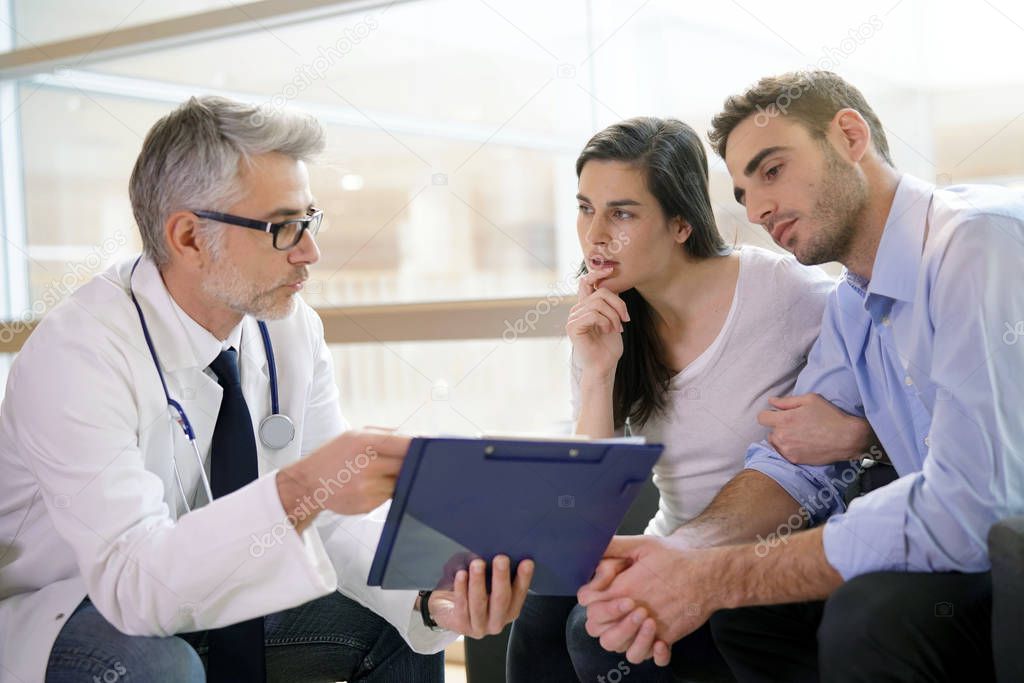 Couple meeting medical specialist at hospital