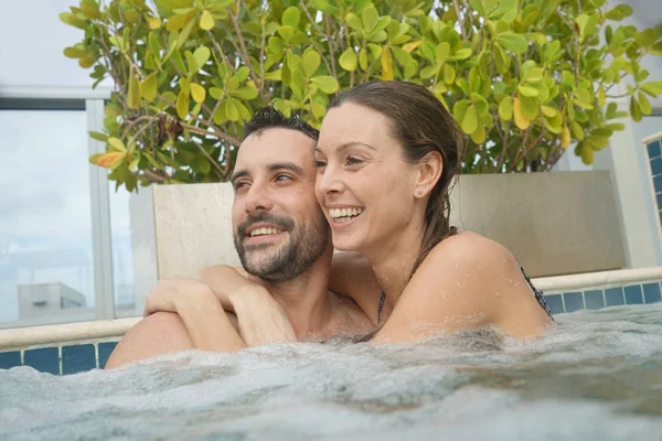 happy Couple relaxing in jacuzzi pool