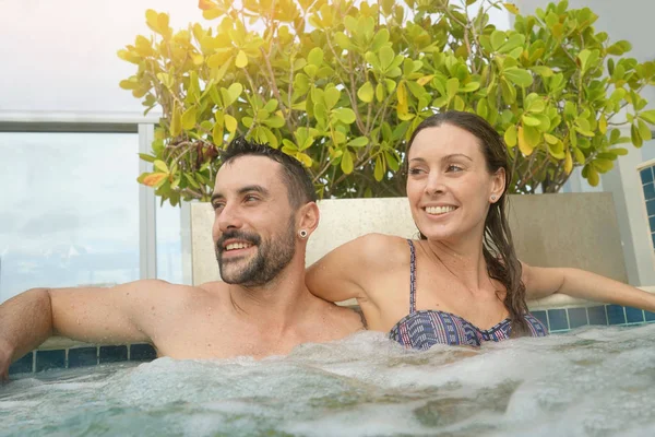 happy Couple relaxing in jacuzzi pool