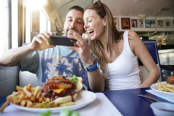 Young Couple Fast Food Restaurant Taking Picture Burger — Stock Photo, Image