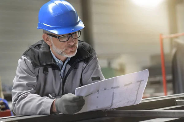 Metalworker Factory Reading Instructions Blueprint Stock Image