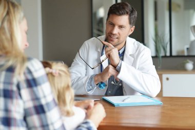 Doctor with patient in office clipart