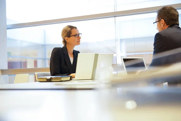 Executive people working on laptop in meeting room