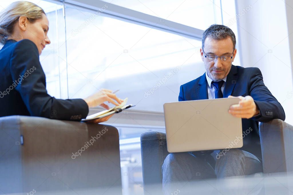 Executive people meeting in airport waiting room