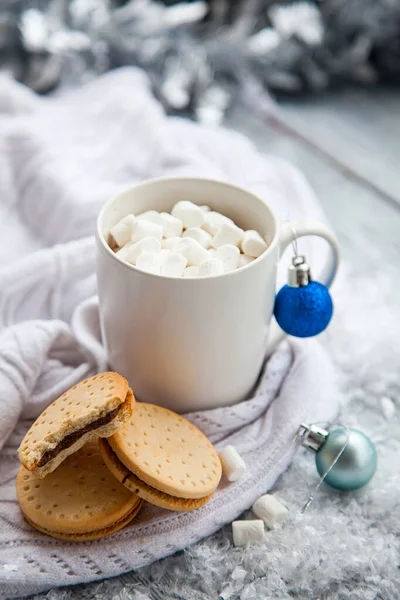 Cup of cacao with marshmallow and cookies on Christmas wooden background