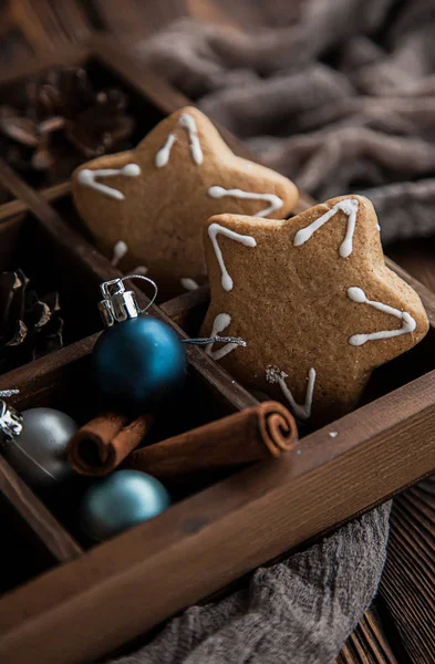 Wooden box with Christmas items and gingerbread.